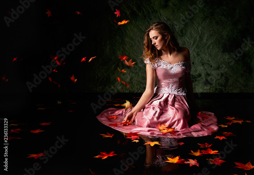 Autumn leaves in the water with a model. 