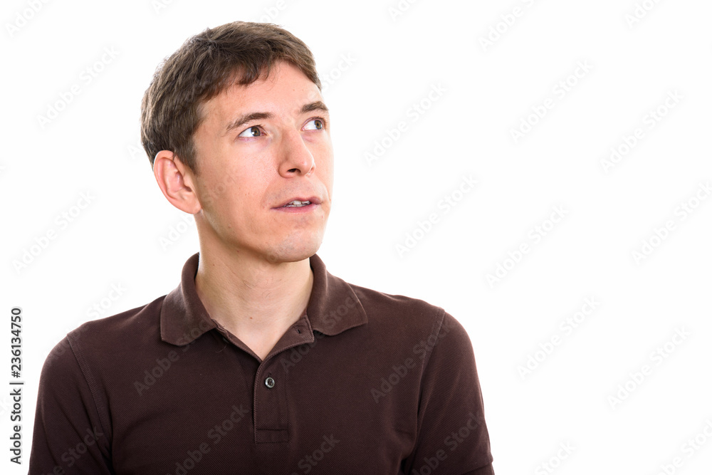 Studio shot of man thinking while looking up Studio shot of man thinking while looking up