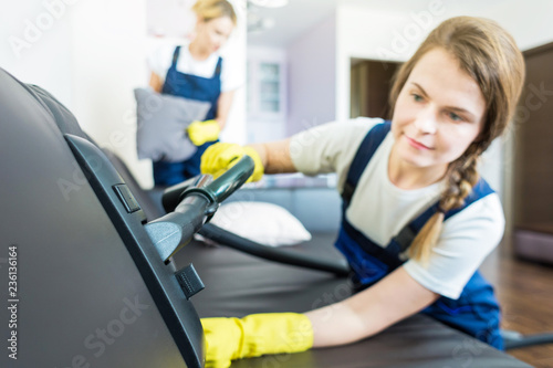 Cleaning service with professional equipment during work. professional kitchenette cleaning, sofa dry cleaning, window and floor washing. man and women in uniform, overalls and rubber gloves © xartproduction