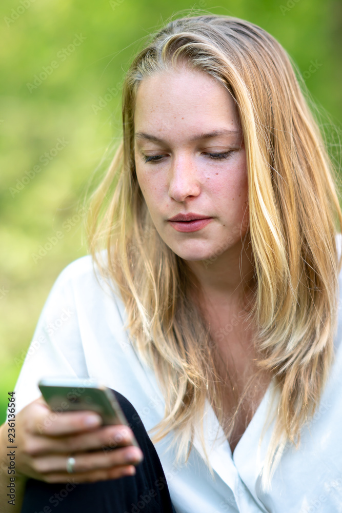 Young woman using tablet computer or smartphone