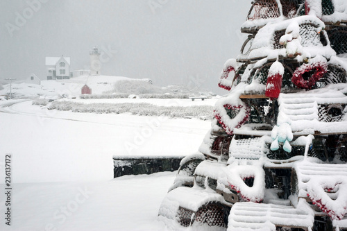 Snow Covered Holiday Lobster Trap Tree by Lighthouse in Maine