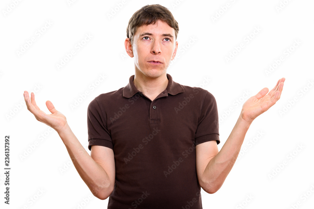Fototapeta premium Studio shot of man looking confused with both arms raised