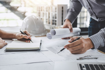 Construction and structure concept of Engineer or architect meeting for project working with partner and engineering tools on model building and blueprint in working site