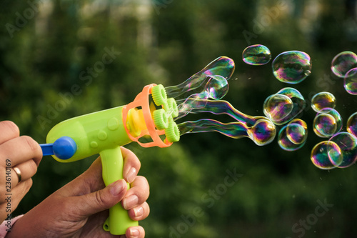 Image of toy gun shooting bubbles photo