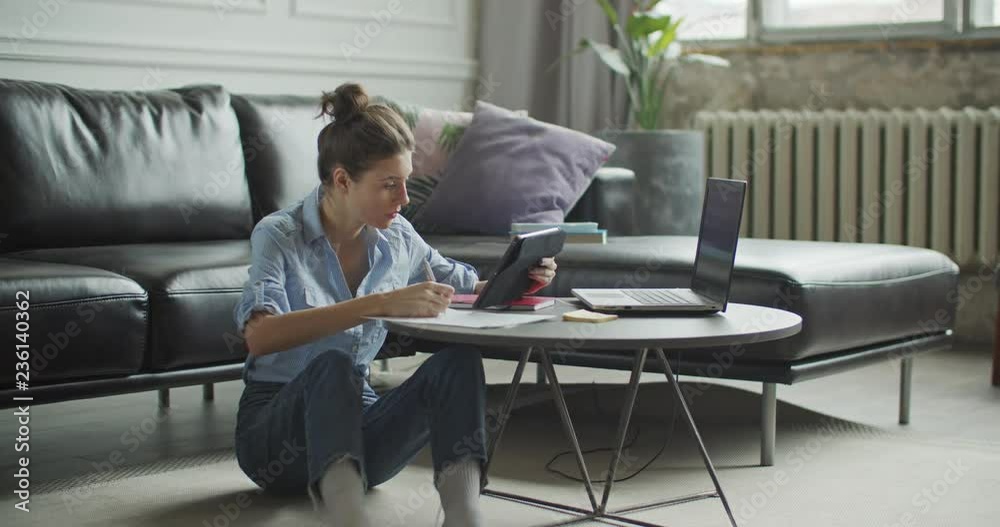 Young woman using digital tablet computer in home Young woman using digital tablet computer in home