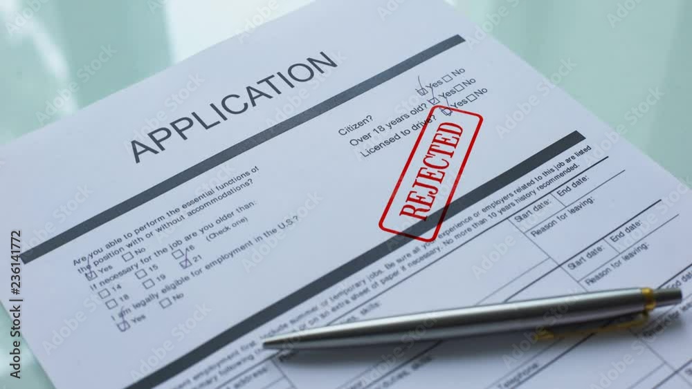Application document rejected, hand stamping seal on official paper, closeup