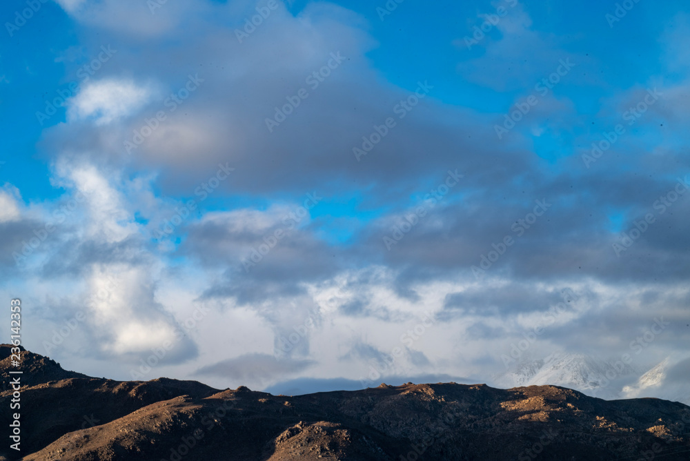 cloudy November sky over Eastern Sierra Nevada hills, mountains, desert valley, California, USA