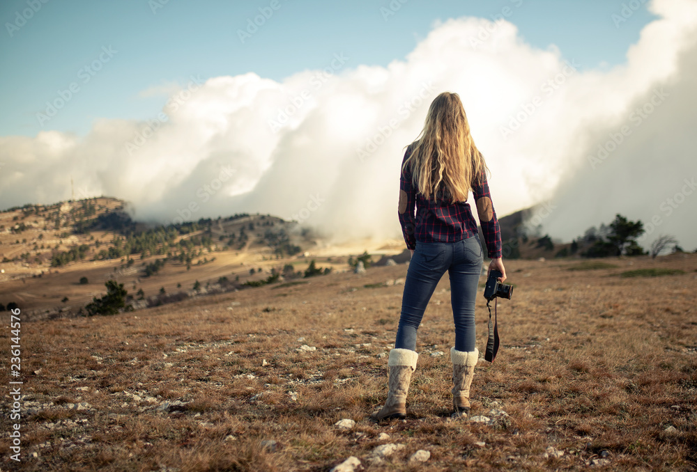 Naklejka premium girl photographer in the mountains