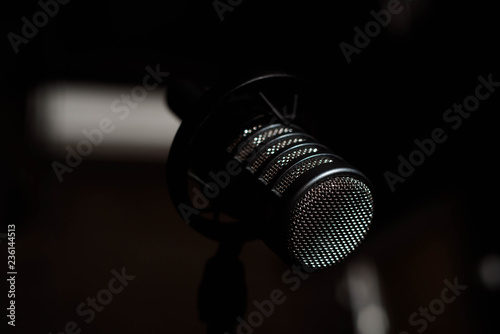 Black vocal microphone is stand in sound recording studio room u