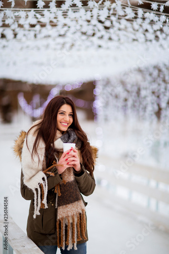 Young woman in a snow park ...