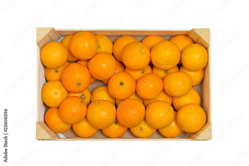 Ripe tasty tangerines in wooden box isolated on white. Winter time.