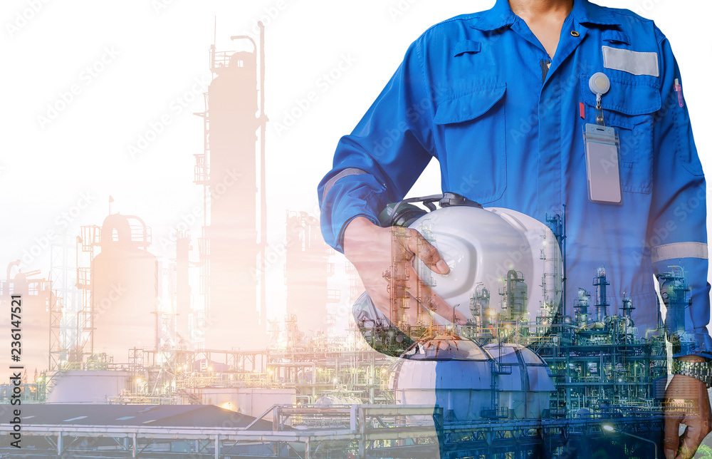 Technician stand hand holding safety helmet with blue uniform on