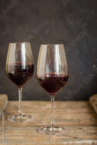 wine - red wine in a transparent glass on a wooden table. Top view. copy space