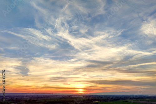 A sunset in a sunny day with a blue sky and clouds in the Galacho del Juslibol rural area, Zaragoza, Aragon region, Spain