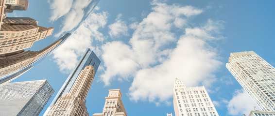 Panorama low angle view of Chicago downtown skylines and reflection, cloud blue sky