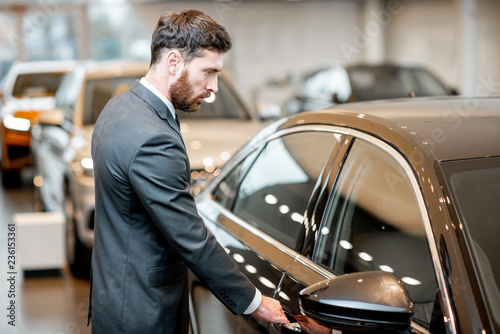 Elegant businessman choosing new luxury car in the showroom © rh2010
