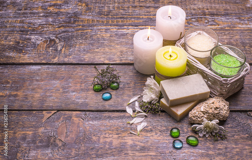 Parfumed salt, natural soap, candles on a wooden background, copy space. photo