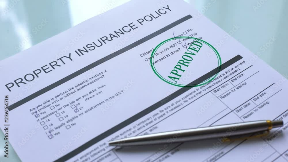 Approved property insurance policy, hand stamping seal on official paper closeup
