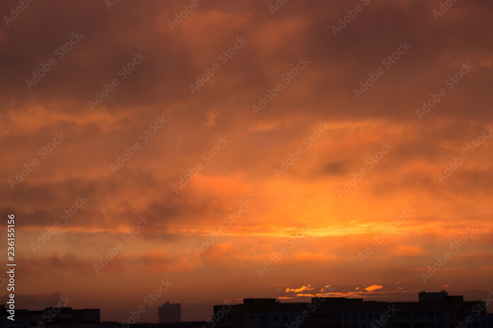 clouds at dawn. Fiery red rising sun behind the clouds. headpiece