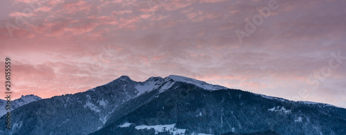 winter mountain landscape panorama at sunset with a colorful sky