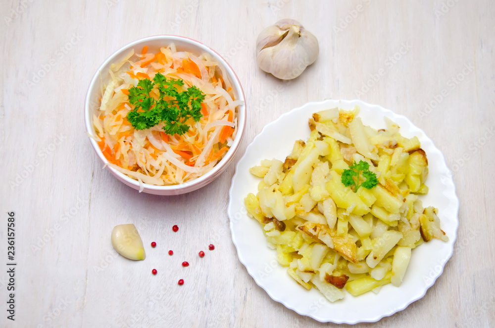 salted cabbage in a plate next to pepper peas and garlic, parsley fried potatoes in a plate salted cabbage in a plate next to pepper peas and garlic, parsley fried potatoes in a plate