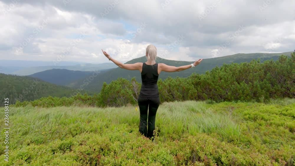 beautiful young woman walking in the mountains beautiful young woman walking in the mountains