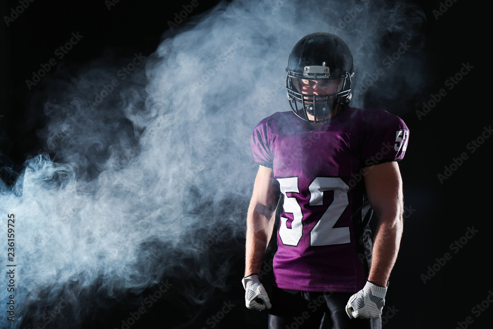 American football player wearing uniform on dark background. Space for text