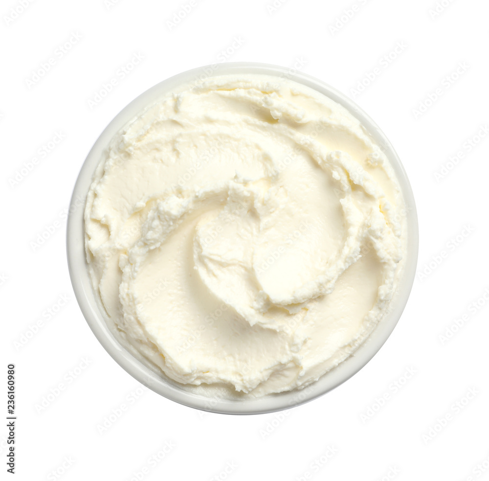 Bowl of tasty cream cheese on white background, top view