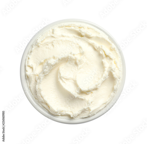 Bowl of tasty cream cheese on white background, top view
