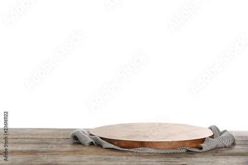 Wooden board and napkin on table against white background