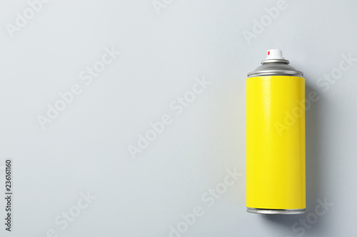 Can of spray paint on color background, top view. Space for text