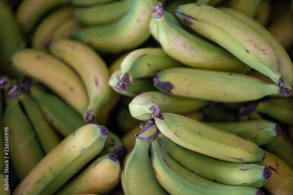 Bananas stacked together at market