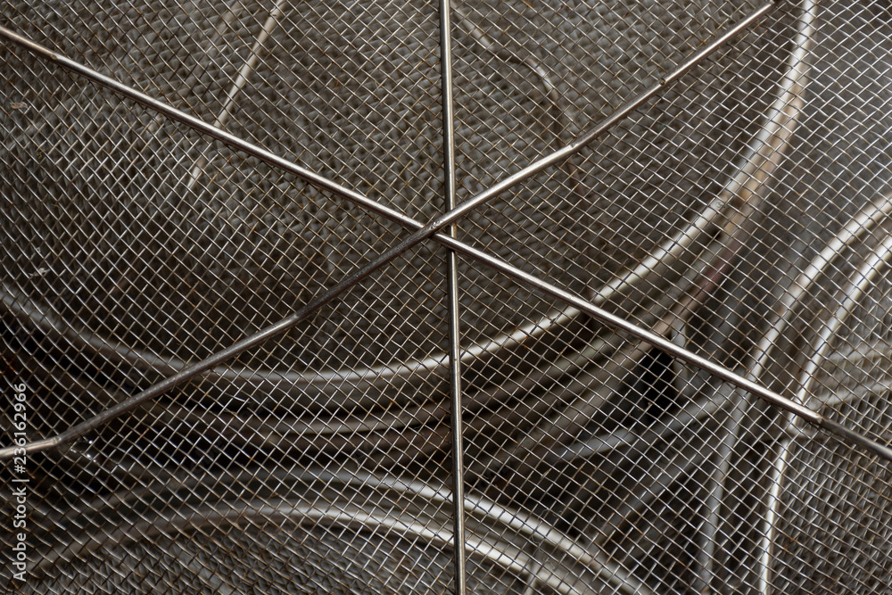 Obraz premium Used steel wire mesh filter. Centre in sharp focus and surface curves away from view.