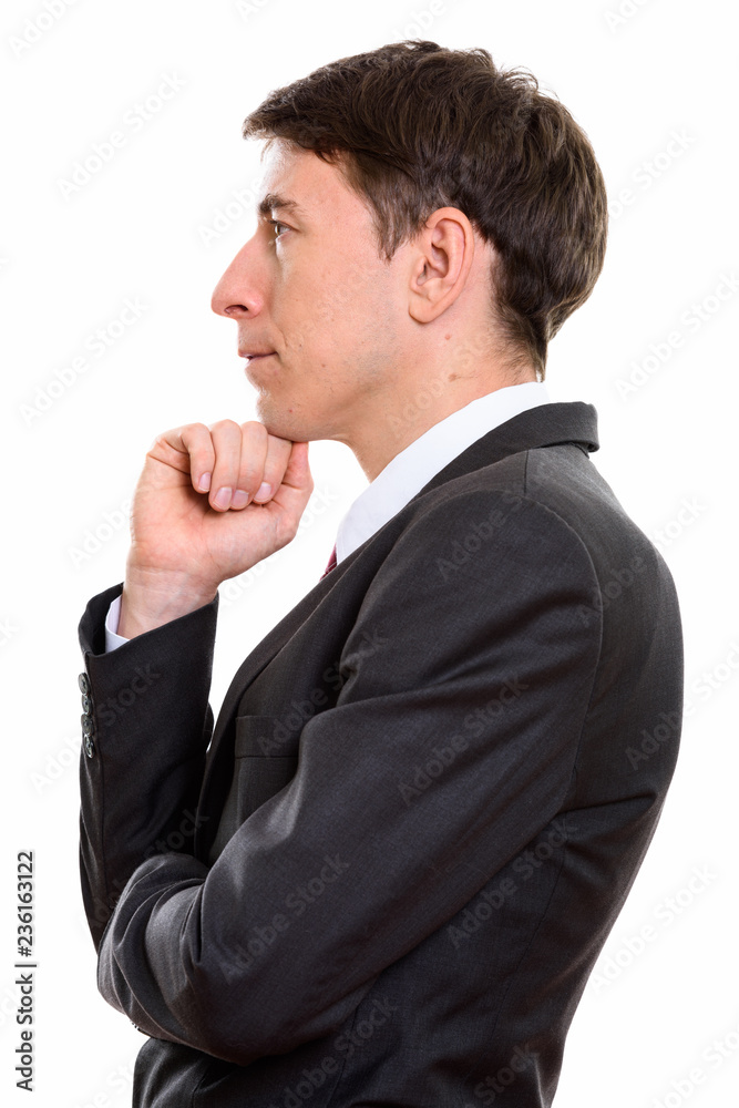 Profile view of businessman thinking with hand on chin