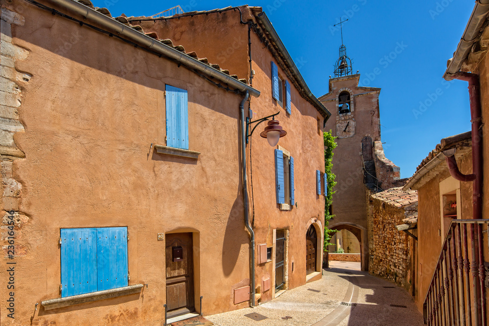 Belltower in Roussillon. Tower and houses with red ocher color, Roussillon, Provence, Luberon, Vaucluse, France