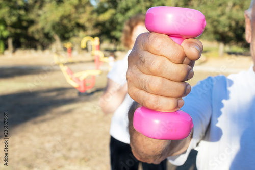 older people doing sports with outdoor weights