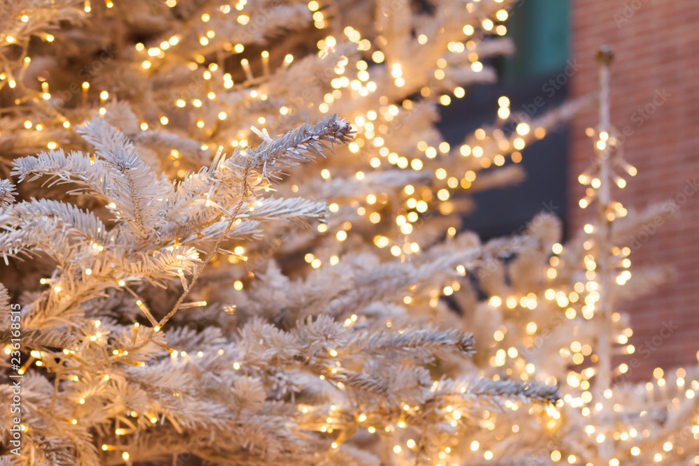 Silver Christmas tree with golden shining garlands
