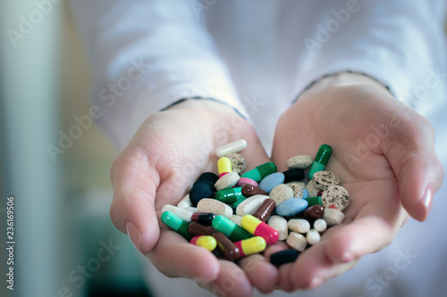 colorful pills capsules in a doctor's hands © Angelika Smile