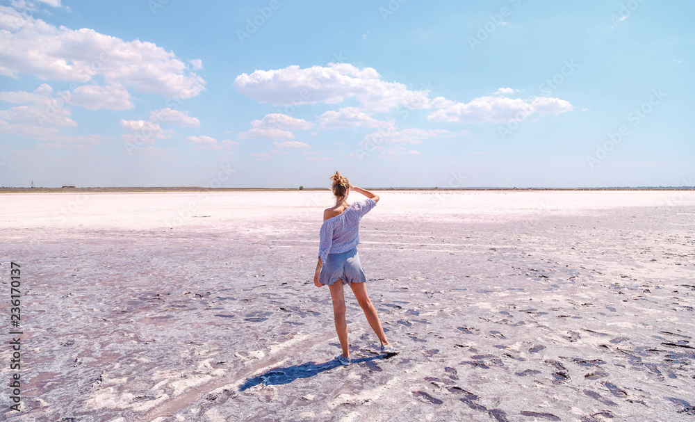 A girl on a pink salty lake
