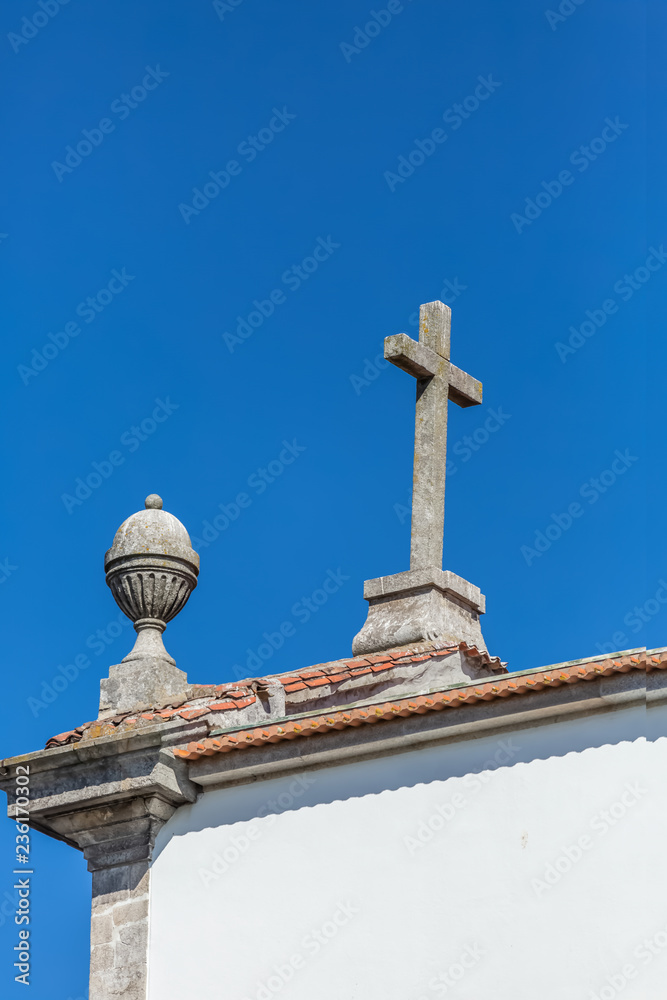 Roof view of Christian religious church, with cross and pinnacle, in Porto, Portugal Roof view of Christian religious church, with cross and pinnacle, in Porto, Portugal