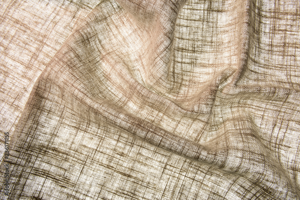 Fototapeta premium Rough fabric texture transparent waves for abstract background with scissors