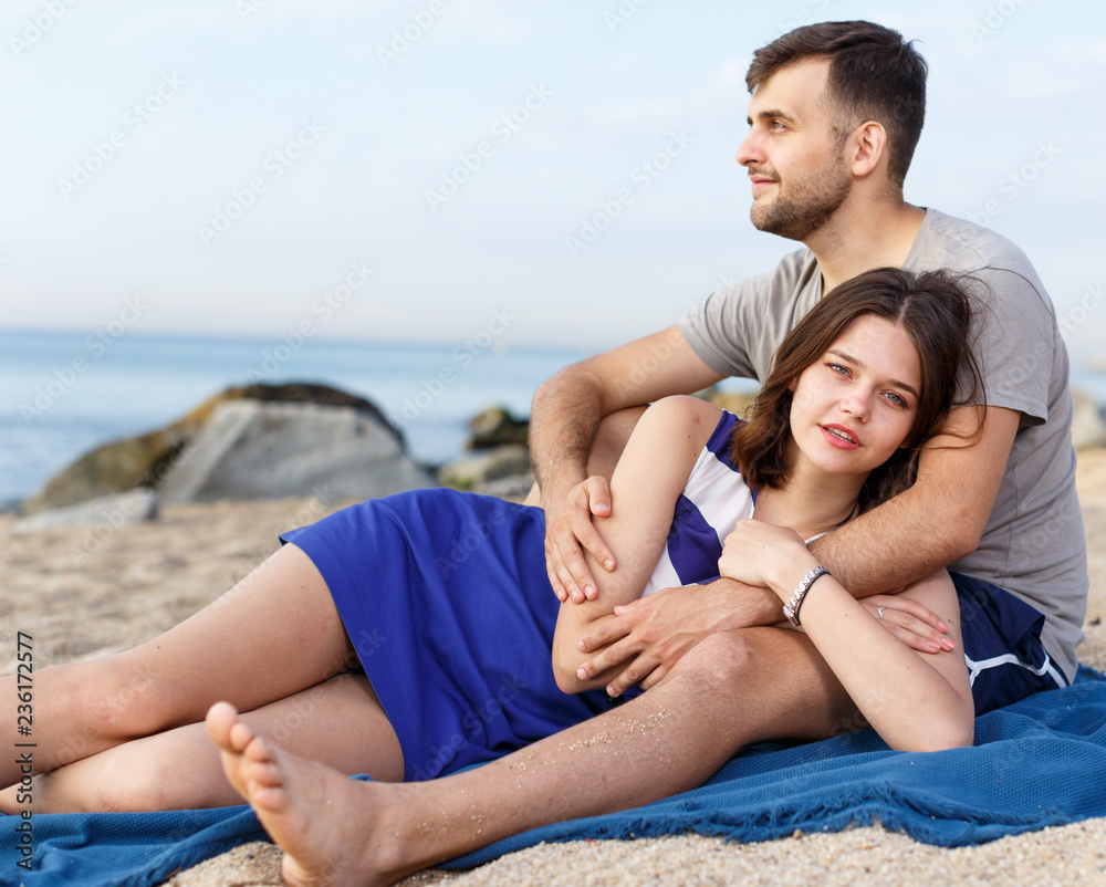 Fototapeta premium Positive loving couple resting and hugging