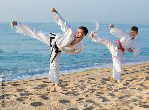  boy and a teacher are practicing karate