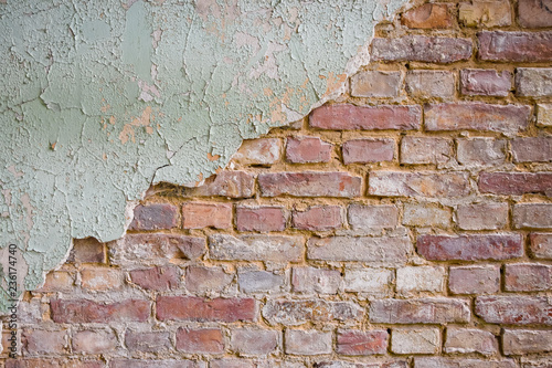 Closeup of an old brick wall with flaking paint