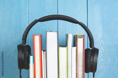 headphone and books on blue background photo