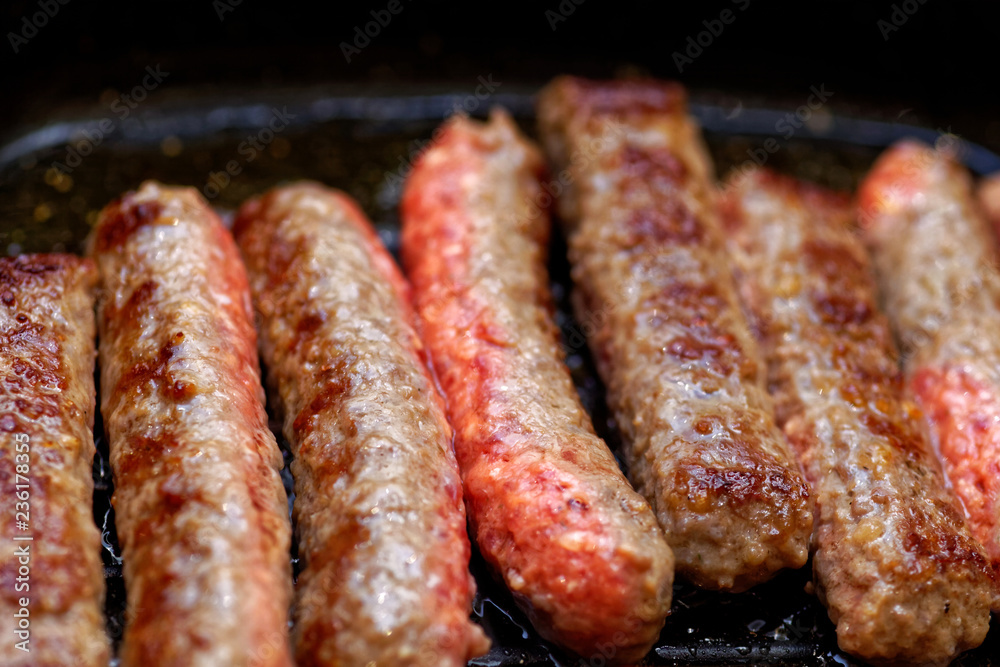 Close up grilled homemade meat sausages. Shallow depth a field