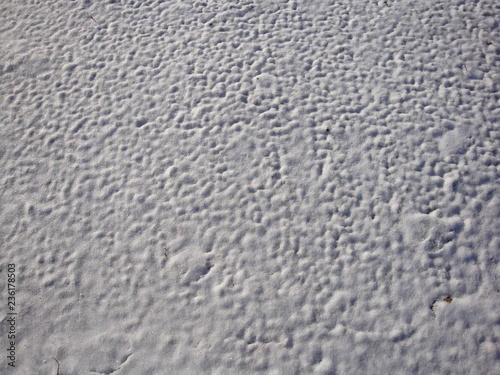 Beautiful white snow texture, formed by the winter wind. Waves and Dunes