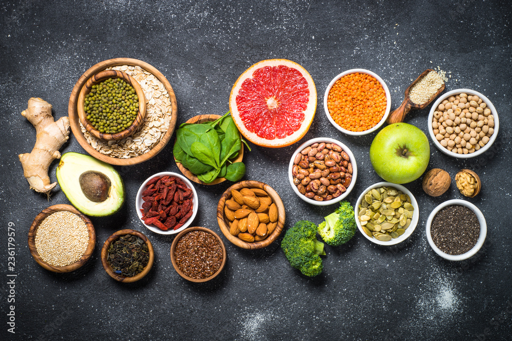 Superfoods on black stone background. 