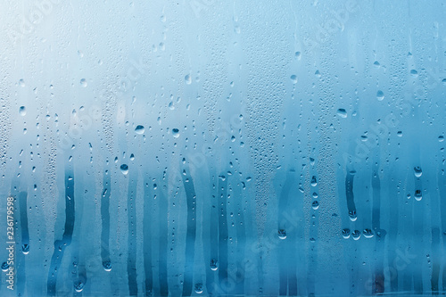 Condensation on the clear glass window. Water drops. Rain. Abstract background texture photo