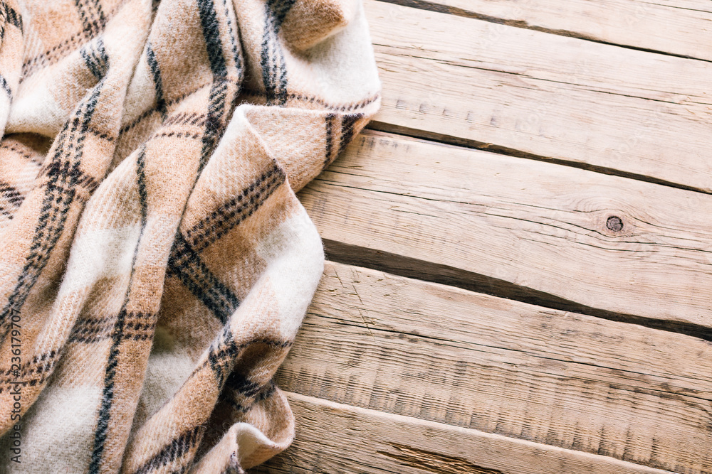 Obraz premium Plaid wool plaid on old wooden background